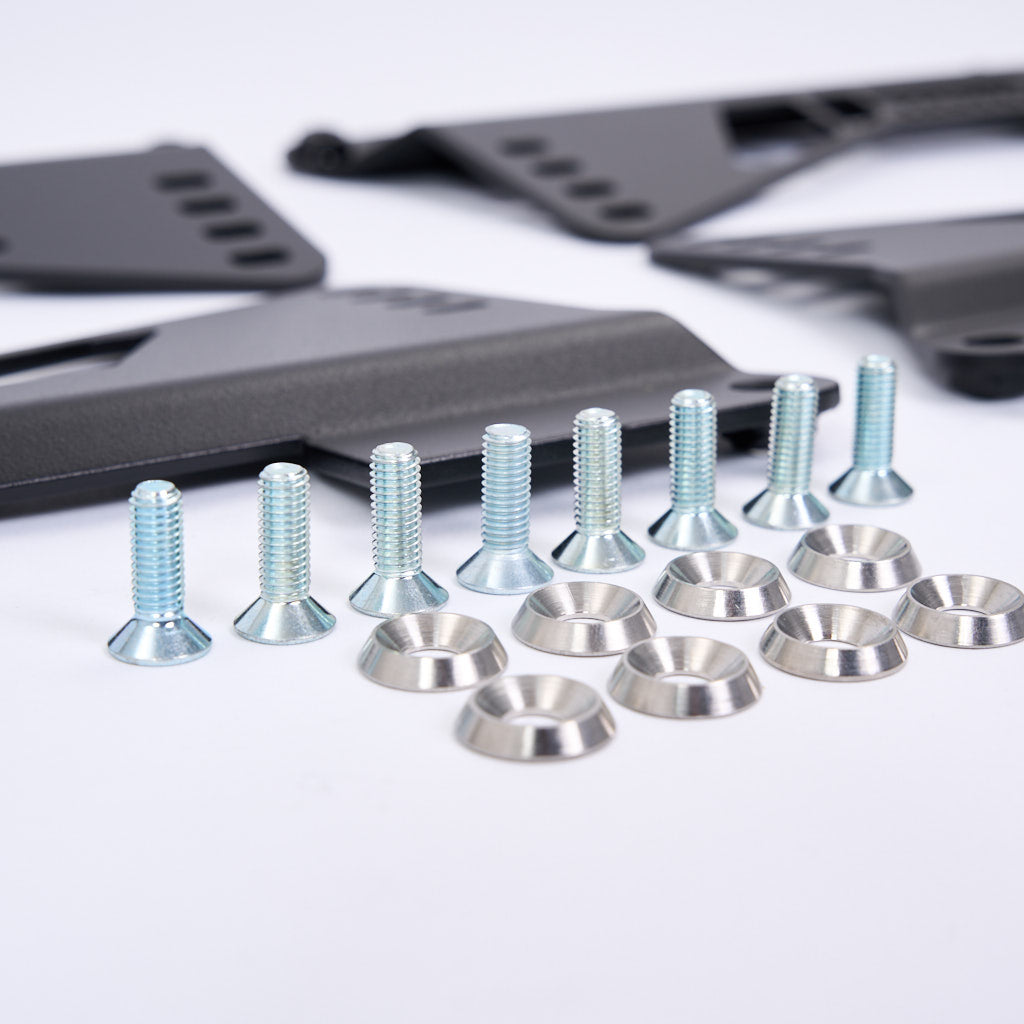 Silberne Schrauben und Unterlegscheiben mit schwarzen Metallhaltern von 55Parts, ideal als Stahl Seitenadapter für OEM BMW Laufschienen (E-, F-, G-Serien) Schalensitze. Perfekte Lösung für die Montage Ihres Recaro Pole Position Sitzes.