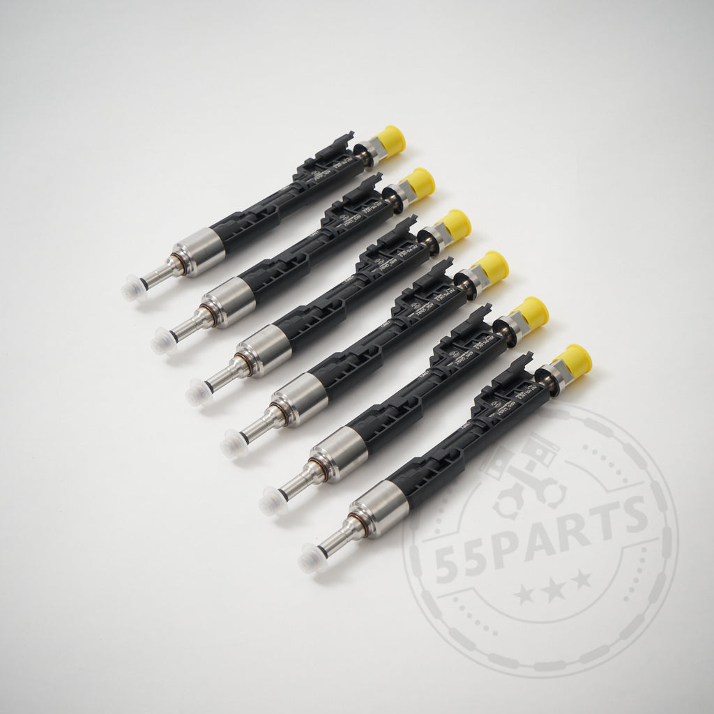 Sieben 55Parts Upgrade (M5) Injektoren-Einspritzdüsen ab 700 PS passend für BMW M2 Competition, M3 und M4 S55-Motoren mit schwarz/silbernem Gehäuse und gelben Kappen sind diagonal auf einer weißen Fläche angeordnet.
