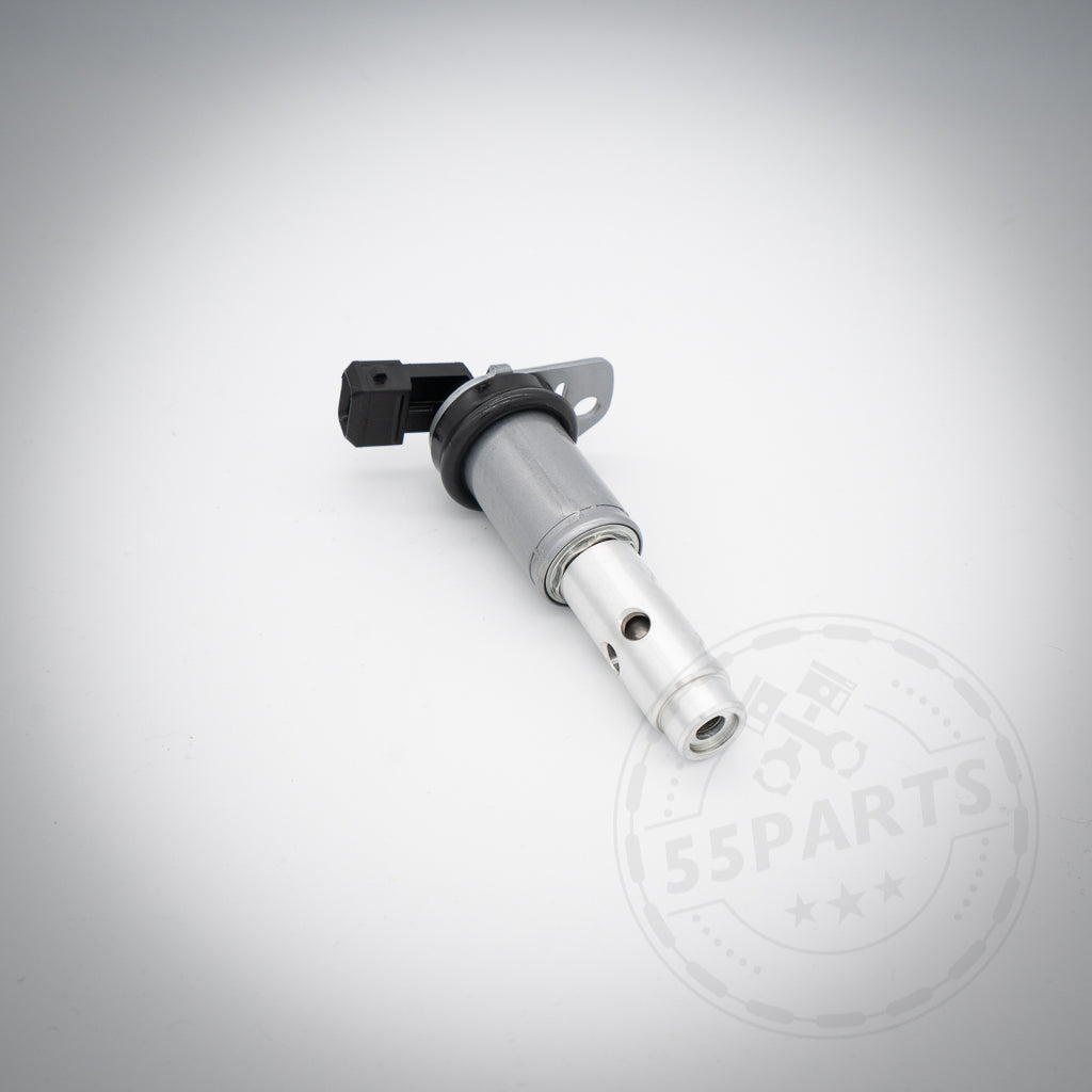 Das 55Parts Vanos Magnetventil, passend für BMW 130i, 135i, 1er M Coupé, 330i, 335i(x) N52/N53/N54, ist ein Kfz-Sensor aus Metall mit schwarzem Kunststoffanschluss für Nockenwellenverstellung und VANOS-Systeme. Abbildung auf weißem Hintergrund.